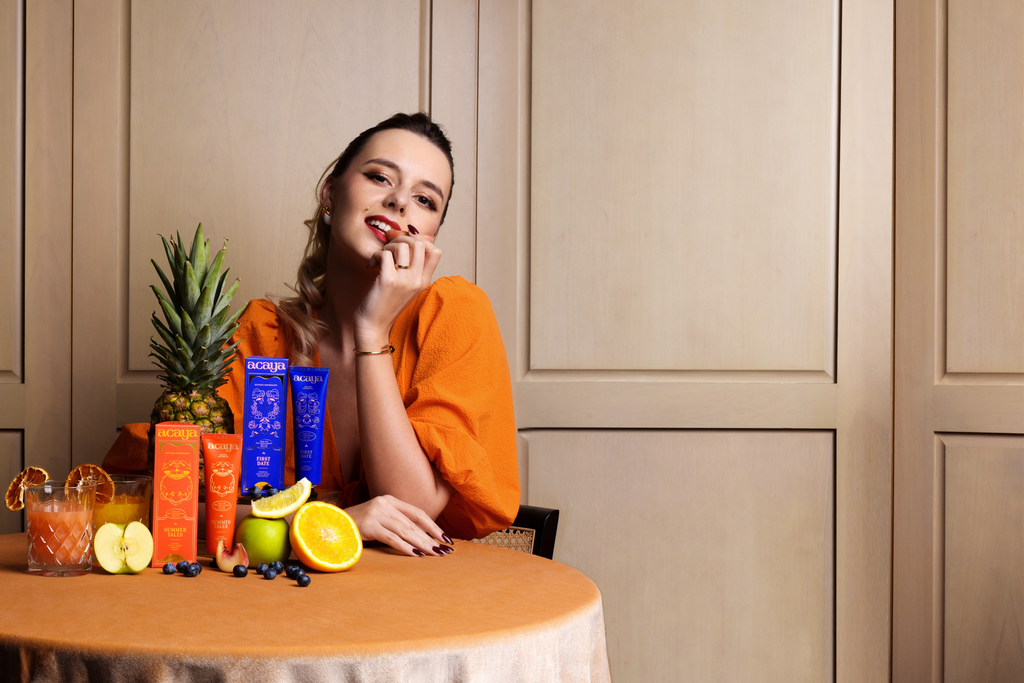 Acaya model eating fruit with product collection